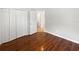 An inviting bedroom with polished wood floors, closet, and doorway to another room at 2936 Banyan Hill Ln, Land O Lakes, FL 34639