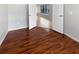 Bedroom with hardwood flooring and an open doorway to other rooms in the house at 2936 Banyan Hill Ln, Land O Lakes, FL 34639