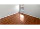 Clean bedroom with hardwood floors and natural light from a large window at 2936 Banyan Hill Ln, Land O Lakes, FL 34639