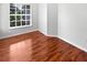 Simple bedroom featuring hardwood floors and a bright window at 2936 Banyan Hill Ln, Land O Lakes, FL 34639
