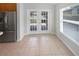 A bright dining area with tile flooring, white trim and a view of the yard through the french doors at 2936 Banyan Hill Ln, Land O Lakes, FL 34639