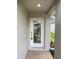 Front door with decorative glass and a covered porch, offering curb appeal at 2936 Banyan Hill Ln, Land O Lakes, FL 34639