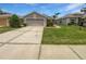 Charming single-story home with a well-manicured lawn and a two-car garage with extended driveway at 2936 Banyan Hill Ln, Land O Lakes, FL 34639