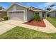 Inviting single-story home with well-maintained landscaping and an extended driveway at 2936 Banyan Hill Ln, Land O Lakes, FL 34639