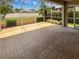A spacious screened lanai with brick pavers offers a relaxing outdoor living area at 2936 Banyan Hill Ln, Land O Lakes, FL 34639