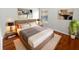 Comfortable main bedroom with hardwood floors, a cozy rug, and stylish decor at 2936 Banyan Hill Ln, Land O Lakes, FL 34639