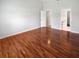 Main bedroom with hardwood floors and a doorway leading to the Primary bathroom and closet at 2936 Banyan Hill Ln, Land O Lakes, FL 34639