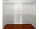 A walk-in closet with wire shelving and hardwood floors offers plenty of storage at 2936 Banyan Hill Ln, Land O Lakes, FL 34639