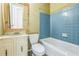 Traditional-style bathroom with blue tile accents, a vanity with a mirror, and neutral fixtures at 5101 Town N Country Blvd, Tampa, FL 33615
