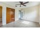 Bedroom featuring a ceiling fan and closet, access to a full bathroom at 5101 Town N Country Blvd, Tampa, FL 33615