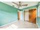 A bright bedroom with terrazzo floors featuring a ceiling fan and a closet at 5101 Town N Country Blvd, Tampa, FL 33615