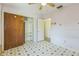 A bright bedroom is decorated with light lavender walls, patterned floors, and large wooden closet doors at 5101 Town N Country Blvd, Tampa, FL 33615