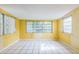 Bonus room featuring tile flooring and a window with blinds at 5101 Town N Country Blvd, Tampa, FL 33615