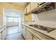 Bright kitchen featuring ample counter space, wood-look floors, and views into the dining room at 5101 Town N Country Blvd, Tampa, FL 33615