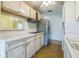 Efficient kitchen with white cabinetry, stainless steel refrigerator, laminate countertops and great sightlines at 5101 Town N Country Blvd, Tampa, FL 33615
