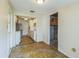 The eat-in kitchen features wood-look flooring, a white refrigerator, and access to the basement at 5101 Town N Country Blvd, Tampa, FL 33615