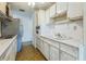 Efficient kitchen with white cabinetry, stainless steel refrigerator, and laminate countertops at 5101 Town N Country Blvd, Tampa, FL 33615