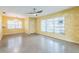 Living room featuring terrazzo floors and ample natural light at 5101 Town N Country Blvd, Tampa, FL 33615