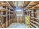 Small storage room with rough framing, open shelving, and a small window at 5101 Town N Country Blvd, Tampa, FL 33615