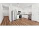 Well-equipped kitchen with stainless steel appliances, granite countertops, and wood-style flooring at 6174 Daerr Ridge St, Zephyrhills, FL 33542