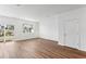 Bright room featuring wood-look flooring, sliding glass doors, and large window at 6174 Daerr Ridge St, Zephyrhills, FL 33542