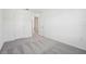 Bright bedroom featuring neutral carpet, white walls, and closet with doors at 6178 Daerr Ridge St, Zephyrhills, FL 33542