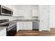 Kitchen with stainless steel appliances, white cabinets, granite countertops at 6178 Daerr Ridge St, Zephyrhills, FL 33542