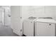 A conveniently located laundry room with modern appliances and storage at 6178 Daerr Ridge St, Zephyrhills, FL 33542
