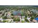 Bird's eye view of a home featuring well-maintained landscaping, a pool, and proximity to a lake at 11018 Pine Lilly Pl, Lakewood Ranch, FL 34202