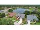 Aerial view of a home situated within a residential community and surrounded by a scenic lake at 11018 Pine Lilly Pl, Lakewood Ranch, FL 34202
