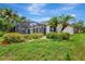 Well-maintained backyard with mature landscaping, screened-in pool, and serene surroundings at 11018 Pine Lilly Pl, Lakewood Ranch, FL 34202