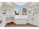 Bathroom featuring a corner soaking tub, dual vanities, and natural light at 11018 Pine Lilly Pl, Lakewood Ranch, FL 34202