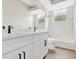 Bathroom featuring double sink vanity with matte black hardware and fixtures, and a window for natural light at 11018 Pine Lilly Pl, Lakewood Ranch, FL 34202