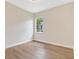 Bedroom with natural light, wood look flooring, white trim, and freshly painted walls at 11018 Pine Lilly Pl, Lakewood Ranch, FL 34202