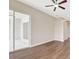 Bedroom with archway entrance, closet, ceiling fan, and wood floors at 11018 Pine Lilly Pl, Lakewood Ranch, FL 34202