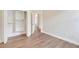 Bedroom with closet, natural light, wood look flooring, white trim, and freshly painted walls at 11018 Pine Lilly Pl, Lakewood Ranch, FL 34202