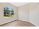 Bedroom with natural light, wood look flooring, white trim, and freshly painted walls at 11018 Pine Lilly Pl, Lakewood Ranch, FL 34202