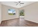 Light-filled bedroom with sliding glass doors that lead to a pool area, plus ceiling fan at 11018 Pine Lilly Pl, Lakewood Ranch, FL 34202