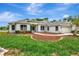 Beautifully landscaped single-story home featuring a well-kept lawn, mulch beds, and an attached garage at 11018 Pine Lilly Pl, Lakewood Ranch, FL 34202