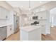 Well-lit kitchen featuring an island, stainless steel appliances, and an open layout at 11018 Pine Lilly Pl, Lakewood Ranch, FL 34202