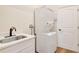 Bright laundry room with stacked washer/dryer and quartz countertop on vanity at 11018 Pine Lilly Pl, Lakewood Ranch, FL 34202