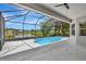 Beautiful screened-in pool and patio offering stunning views of the adjacent lake at 11018 Pine Lilly Pl, Lakewood Ranch, FL 34202