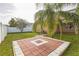 Spacious backyard features a brick paver patio, well-maintained lawn and partial fence at 32717 Coldwater Creek Loop, Wesley Chapel, FL 33545