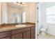 Bathroom with a large mirror, sink and toilet at 32717 Coldwater Creek Loop, Wesley Chapel, FL 33545