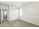 A carpeted room is staged with neutral colored walls and a double door closet at 32717 Coldwater Creek Loop, Wesley Chapel, FL 33545