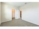 Bright bedroom with neutral paint and plush carpeting, near a walk-in closet and en suite at 32717 Coldwater Creek Loop, Wesley Chapel, FL 33545