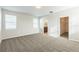 Bedroom featuring plush carpet, neutral paint, and natural light, near bathroom and closet at 32717 Coldwater Creek Loop, Wesley Chapel, FL 33545