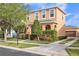 Charming two-story home with a detached garage and a well-manicured lawn at 32717 Coldwater Creek Loop, Wesley Chapel, FL 33545