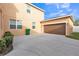 Exterior shot of house featuring attached garage, concrete driveway and manicured landscaping at 32717 Coldwater Creek Loop, Wesley Chapel, FL 33545