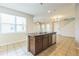 View of a kitchen island and dishwasher with an open floor plan at 32717 Coldwater Creek Loop, Wesley Chapel, FL 33545
